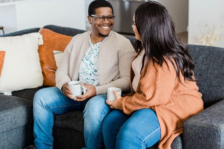 2 people wearing jeans and take cup of tea