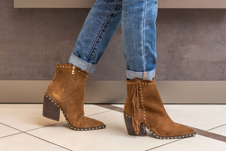 Women wear short cowboy boots and jeans