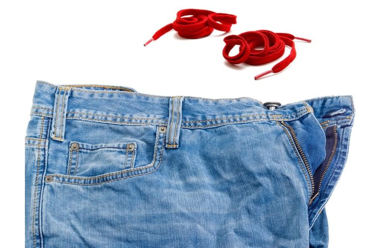 the waistband of jeans with shoelace