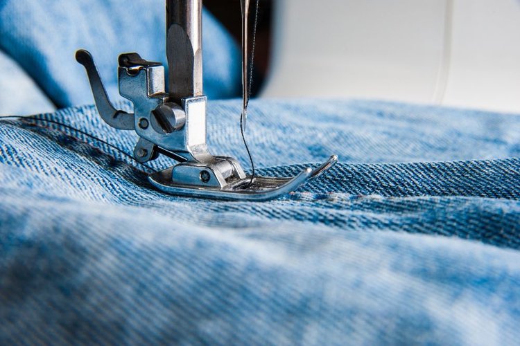 stitching the seam of jeans