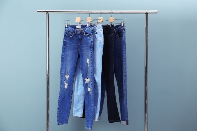 hang jeans on a clothing rack