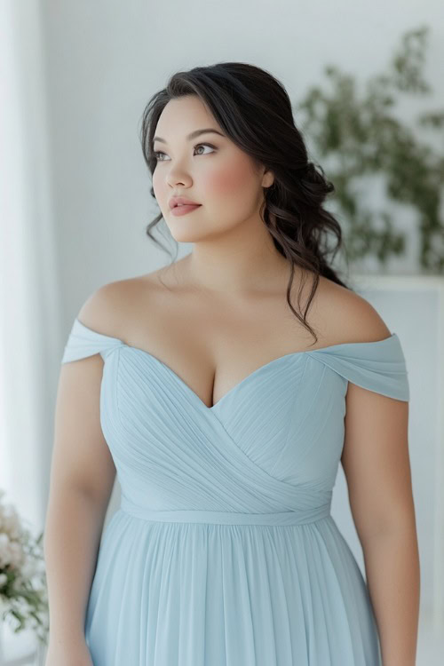 A plus-size woman in a soft blue knee-length dress with a scoop neckline