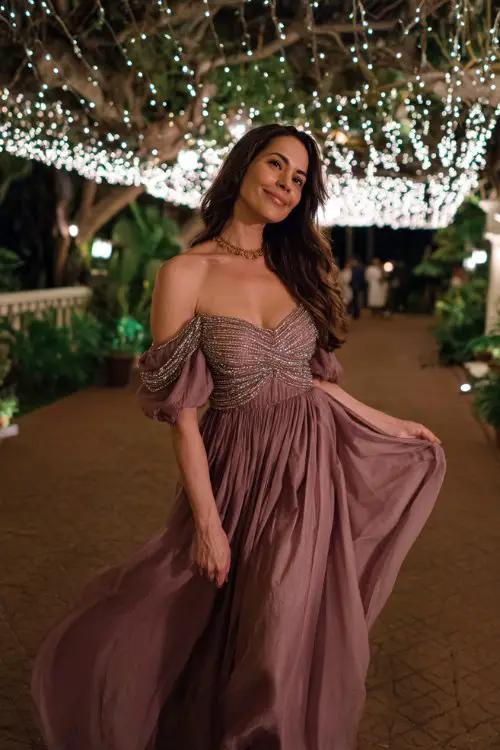A stunning guest in a mauve off-shoulder gown with shimmering beadwork across the neckline and sleeves