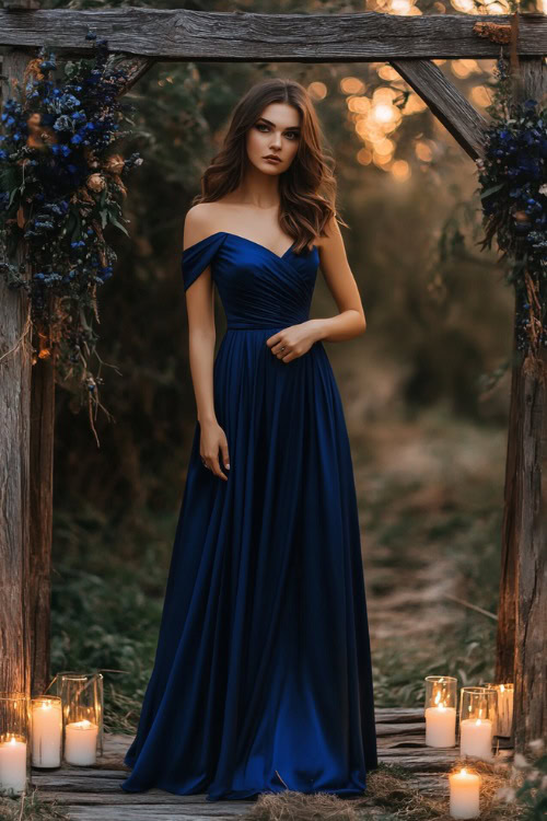 A woman in a cobalt blue one-shoulder midi dress with a structured bodice and A-line skirt