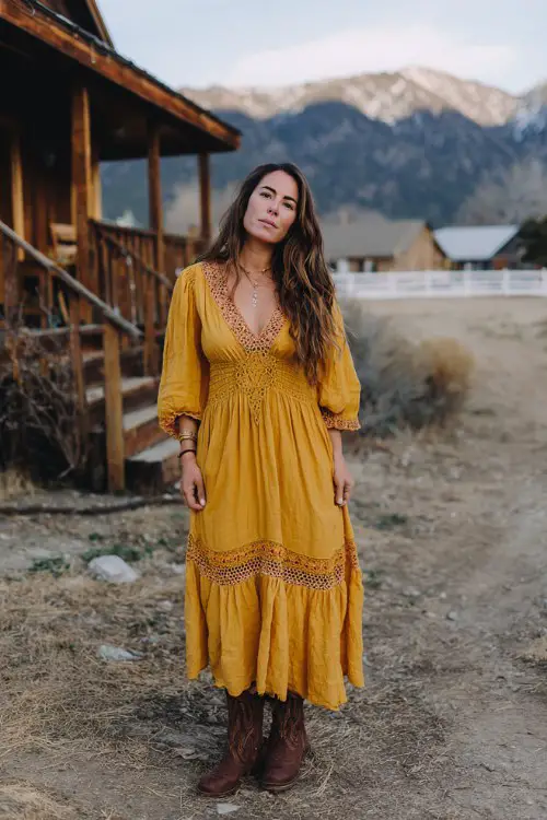 A woman over 30 wears a goldenrod boho-style maxi dress with crochet trim and chocolate brown slouchy boots