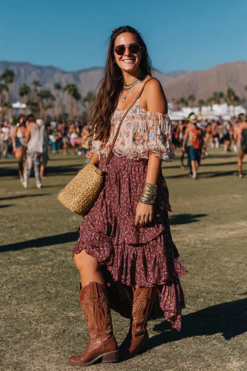 A curvy woman wears brown cowboy boots with a tiered floral midi skirt and a loose embroidered peasant blouse, accessorized with chunky bangles