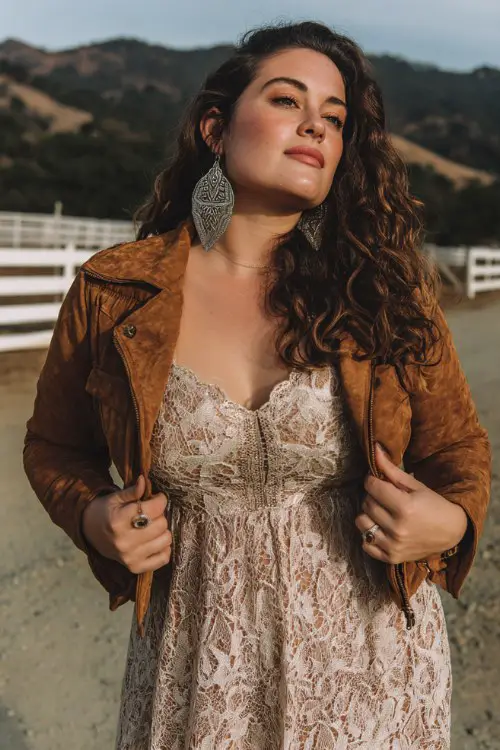 a curvy woman wears a lace dress with a suede jacket