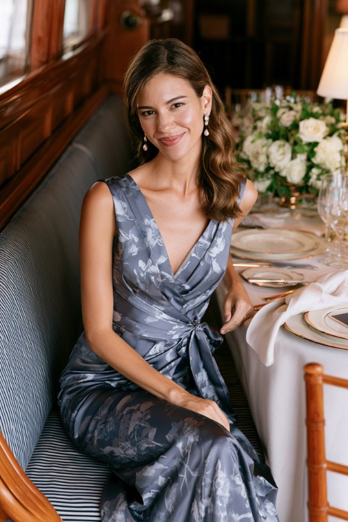 a woman wears a gray floral dress for a classy dinner date night