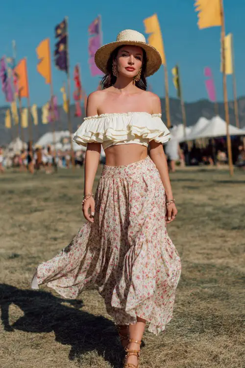 woman wearing a cream off-shoulder ruffle crop top and a flowy floral midi skirt