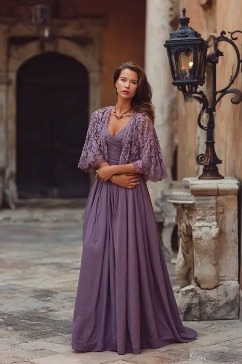 Full body of a mature woman in a dusty lavender gown with lace capelet and A-line silhouette, posing in a formal courtyard with vintage lanterns and stone details 