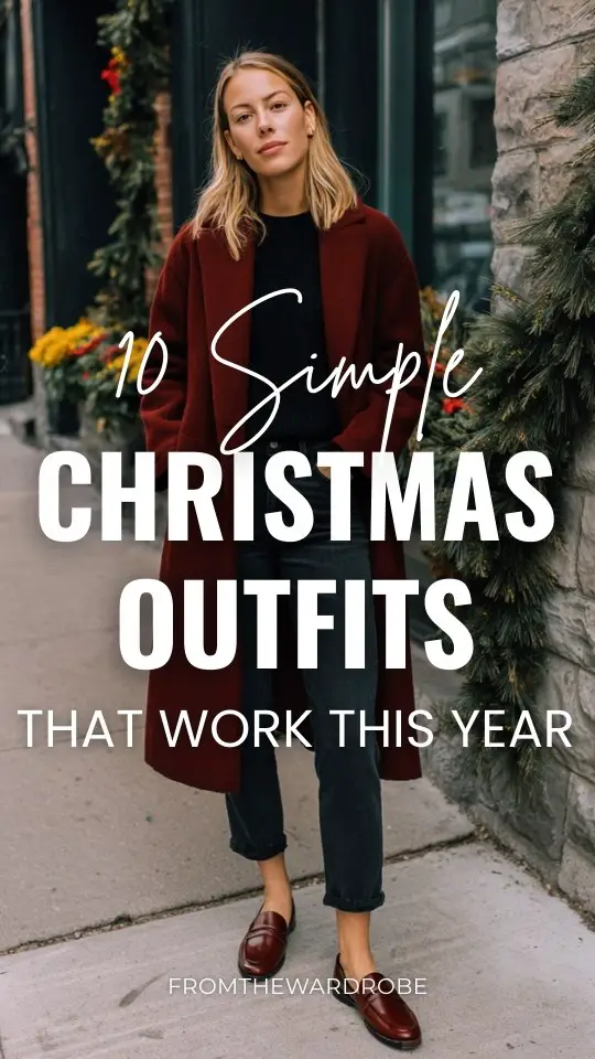 A woman wears a simple Christmas office outfit with a burgundy wool coat over a simple black knit top, straight jeans, leather loafers