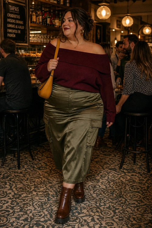 A woman wears a burgundy off-the-shoulder sweater with an olive cargo midi skirt, brown ankle boots, and a mustard shoulder bag.