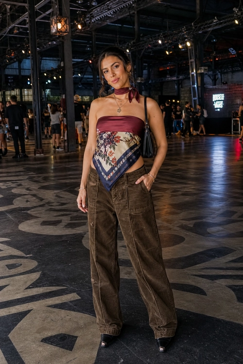 A fashion look featuring a burgundy strapless top, floral scarf detail, brown wide-leg trousers, black shoulder bag, and black pointed footwear.