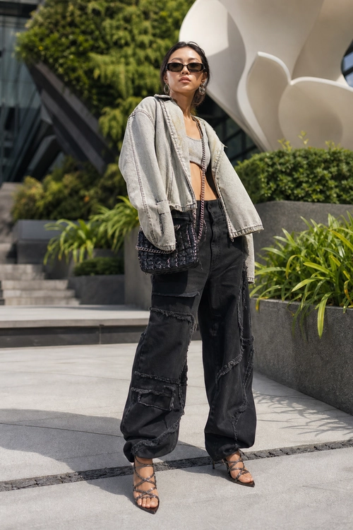 Cropped Jacket and Cargo Jeans Look Fashionable outfit featuring a cropped gray jacket, gray crop top, distressed black cargo jeans, sunglasses, and strappy sandals.