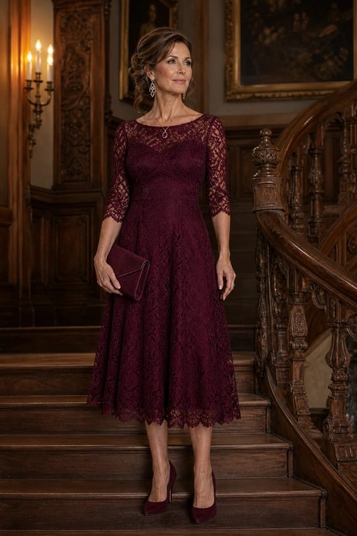 A woman wears a burgundy lace midi dress with three-quarter sleeves, matching clutch, pointed-toe pumps, and delicate jewelry.