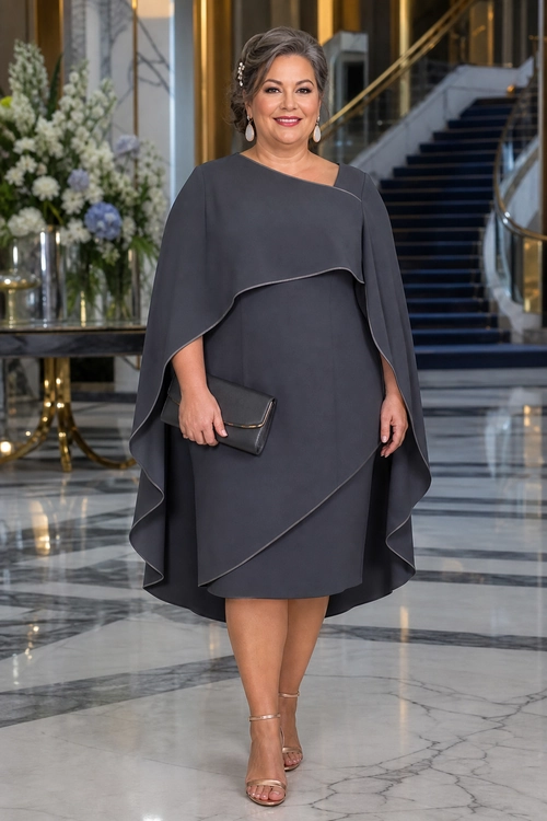 Charcoal Cape Dress Outfit A woman wears a charcoal gray cape-style dress with a matching clutch and strappy metallic heels.