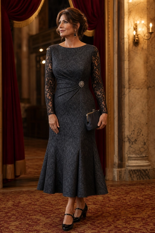 Charcoal Lace-Sleeve Midi Dress Woman wearing a charcoal patterned midi dress with lace sleeves, a waist brooch, black clutch, and Mary Jane heels.