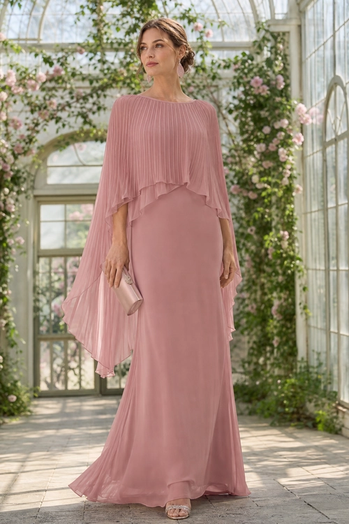 A woman wears a floor-length dusty rose gown with a flowing pleated cape overlay, matching clutch, and metallic sandals.