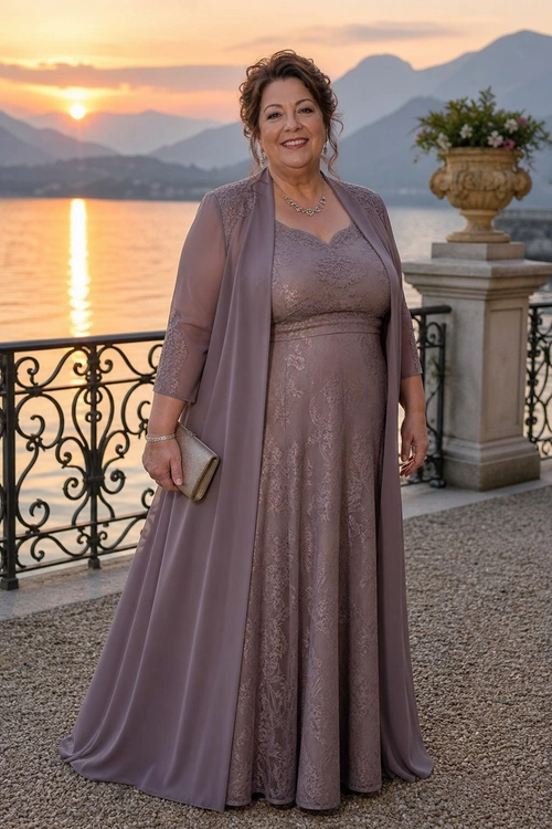 Mauve Lace Evening Dress A mauve floor-length lace dress styled with a matching long open-front overlay and clutch beside a lakeside view.