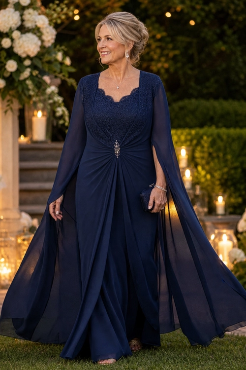 Navy Lace Evening Gown A woman wears a navy floor-length gown with a lace bodice, sheer flowing sleeves, and a jeweled waist detail.