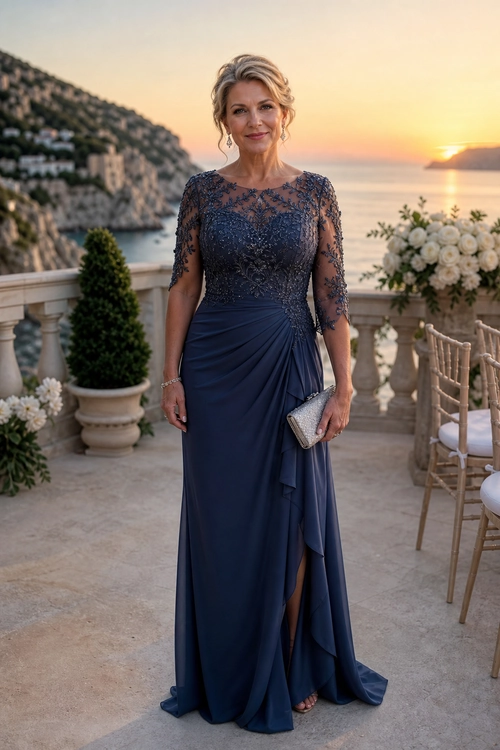 Navy Lace Evening Gown A woman wears a navy blue floor-length gown with a sheer lace bodice, draped skirt, silver clutch, and drop earrings.