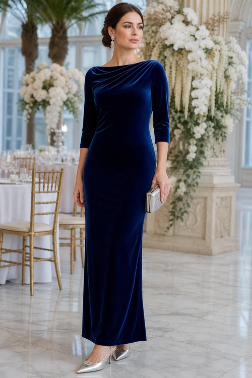 Navy Velvet Evening Dress A woman wears a fitted navy velvet long-sleeve dress with silver pointed-toe heels and a metallic clutch.