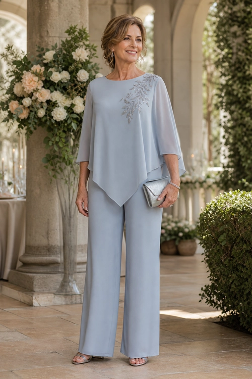 Pale Blue Embellished Evening Outfit A woman wears a pale blue wide-leg outfit with sheer sleeves, a decorative shoulder embellishment, metallic sandals, and a silver clutch.