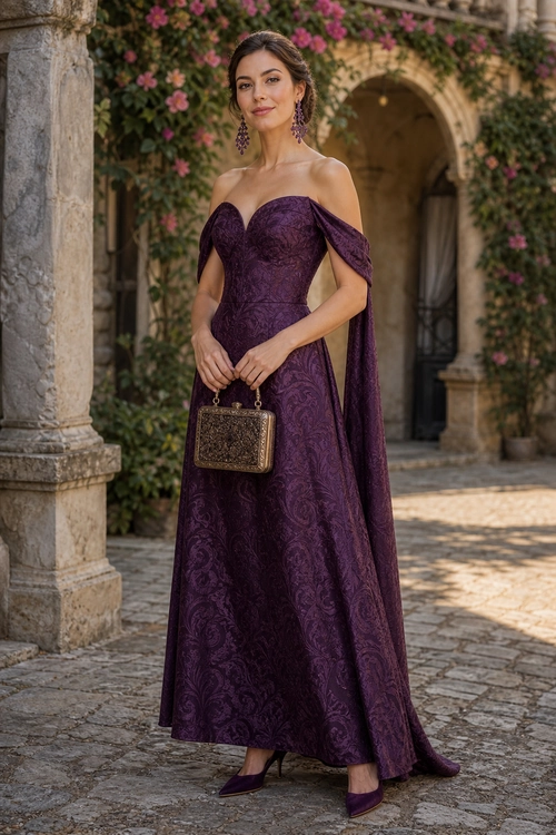 A woman wears a floor-length plum off-shoulder gown with draped sleeves, pointed heels, dangling earrings, and a small ornate handbag.