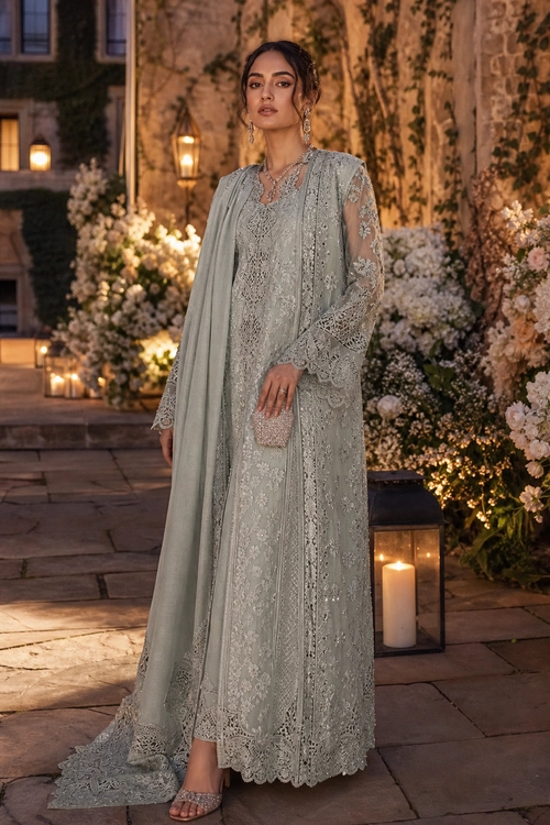 Sage Lace Evening Ensemble Woman wearing a floor-length sage green lace dress with a matching draped scarf, embellished clutch, jewelry, and open-toe heels.