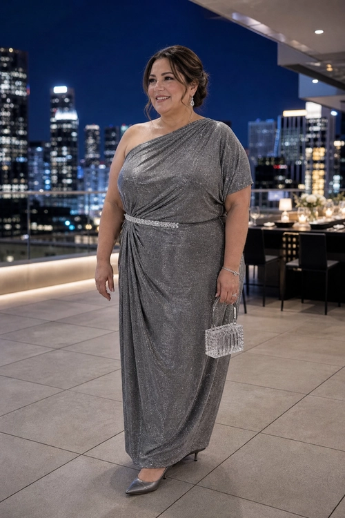 Silver One-Shoulder Evening Gown A woman wears a draped metallic silver one-shoulder gown with pointed pumps and a beaded clutch.