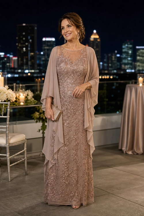 Embellished Taupe Evening Gown Woman wearing a floor-length taupe embellished gown with a sheer draped cape, clutch, and open-toe shoes at an evening event.